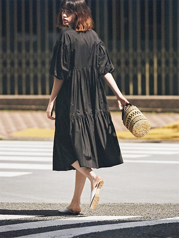ガーリーなデザインは素材次第で辛口にもなれる ⚫︎黒パフスリーブワンピース 47,300円／TSURU By MARIKO OIKAWA　黒リングハンドルバッグ 35,200円／メゾン・エヌ・アッシュ・パリ（エリオポール代官山）　白シューズ 31,900円／PIPPICHIC（ベイジュ）　ティアードやそでのふくらみが強さに転じる素材のハリ。振り切った甘さには白ではなく黒が必須。